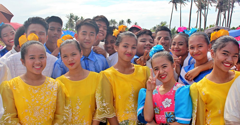 Some local kids are dressed vibrantly as the town celebrates a small festival